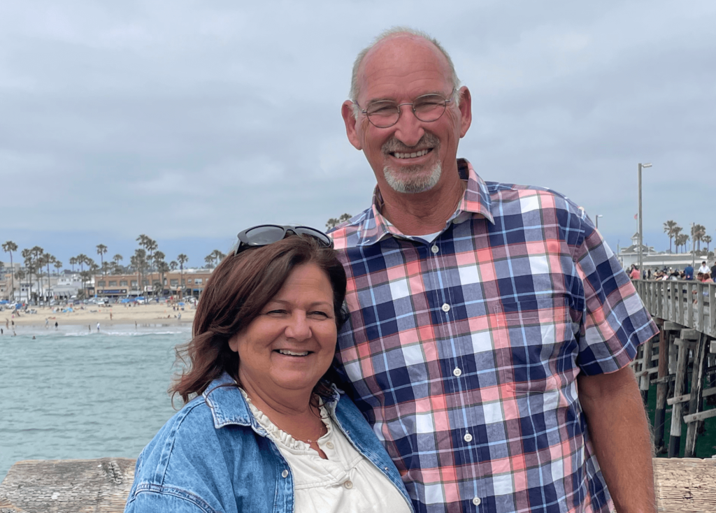 Ed Schroeder and his wife on a pier at the beach